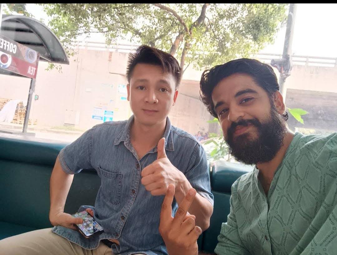 Me with My Vietnam team member outside airport during my Long layover in Hanoi.