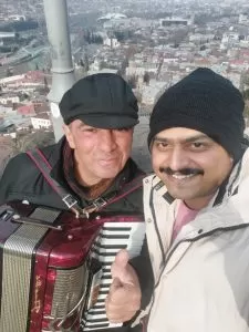 Our Amazing tour of Georgia - Sinoy posing with Georgian musician in Kazbegi